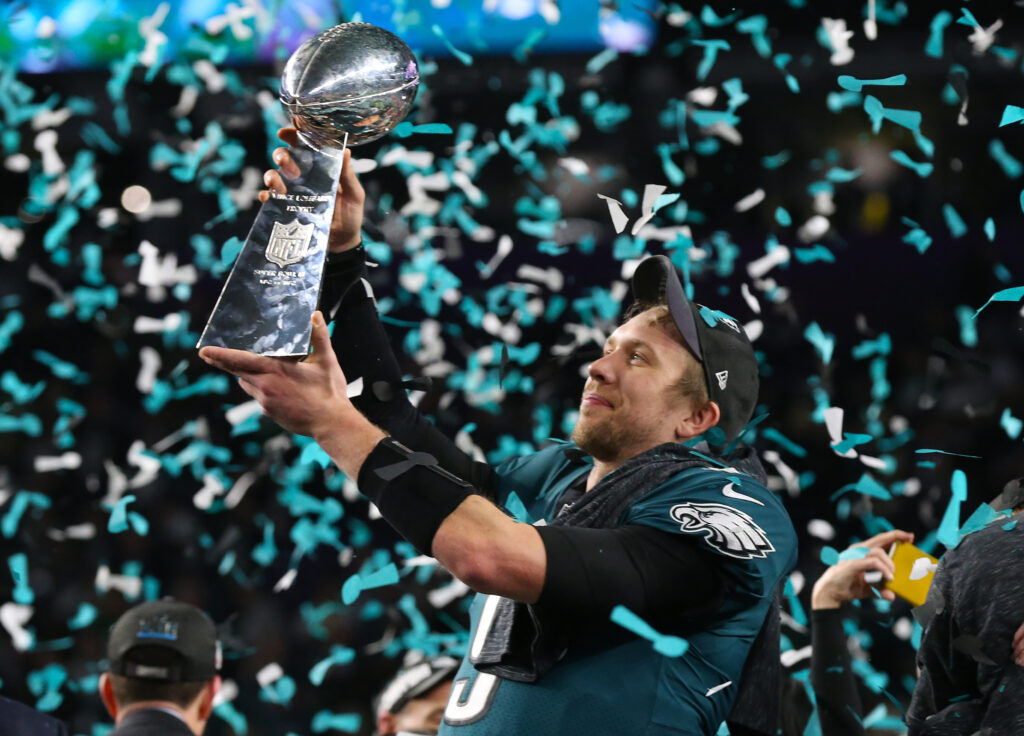 Nick Foles holds up the Lombardi Trophy as confetti falls