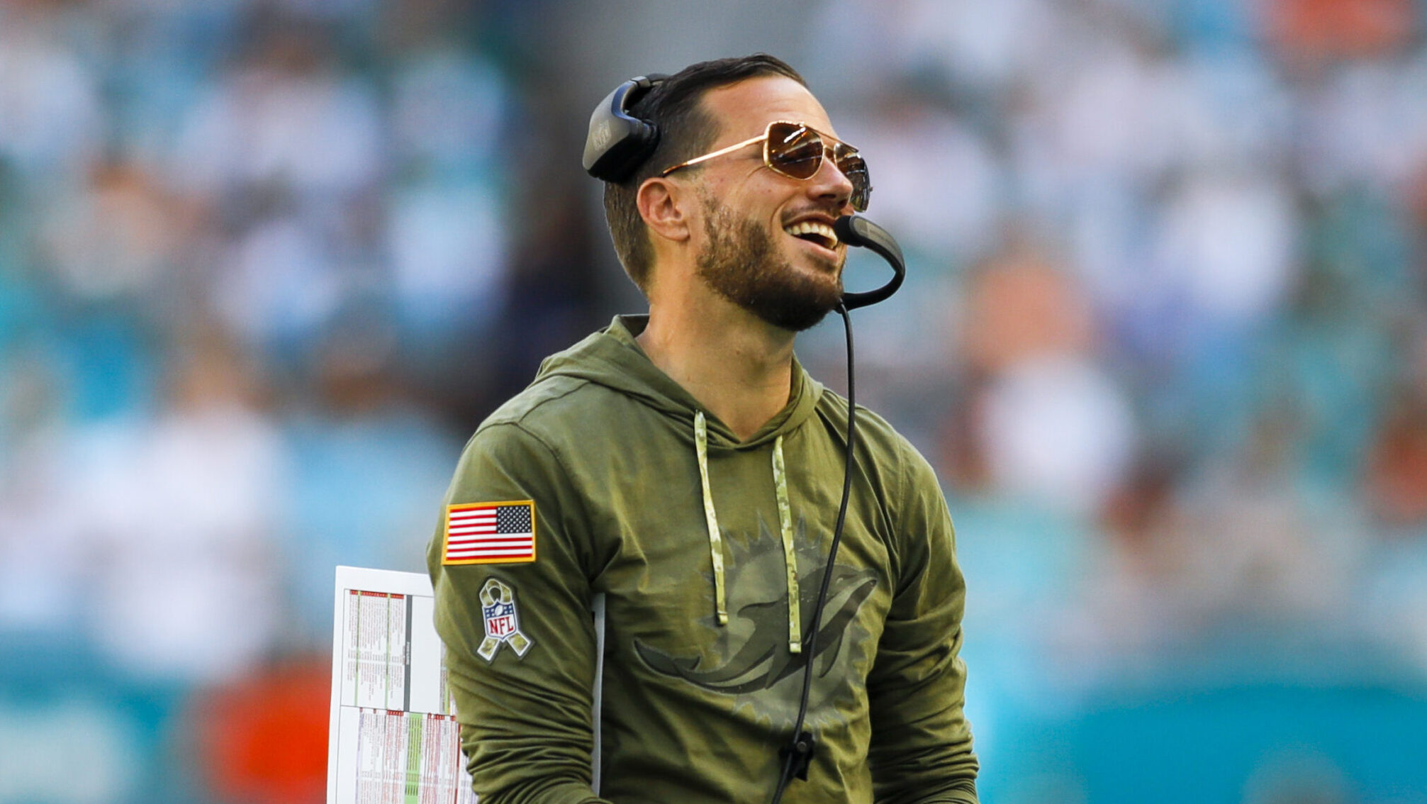 Dolphins HC Mike McDaniel smiles on the sideline.