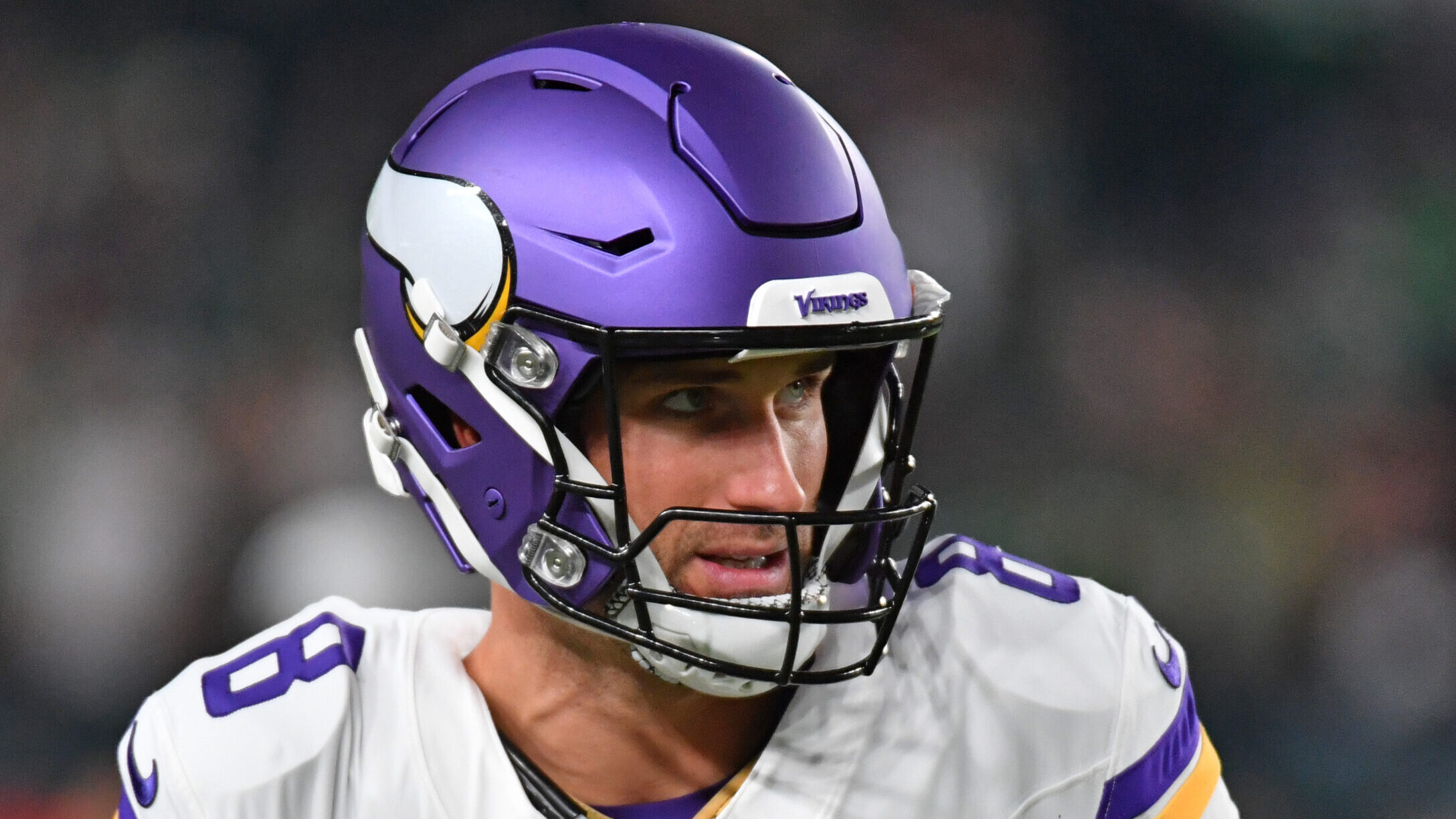 Kirk Cousins looks out while wearing his helmet