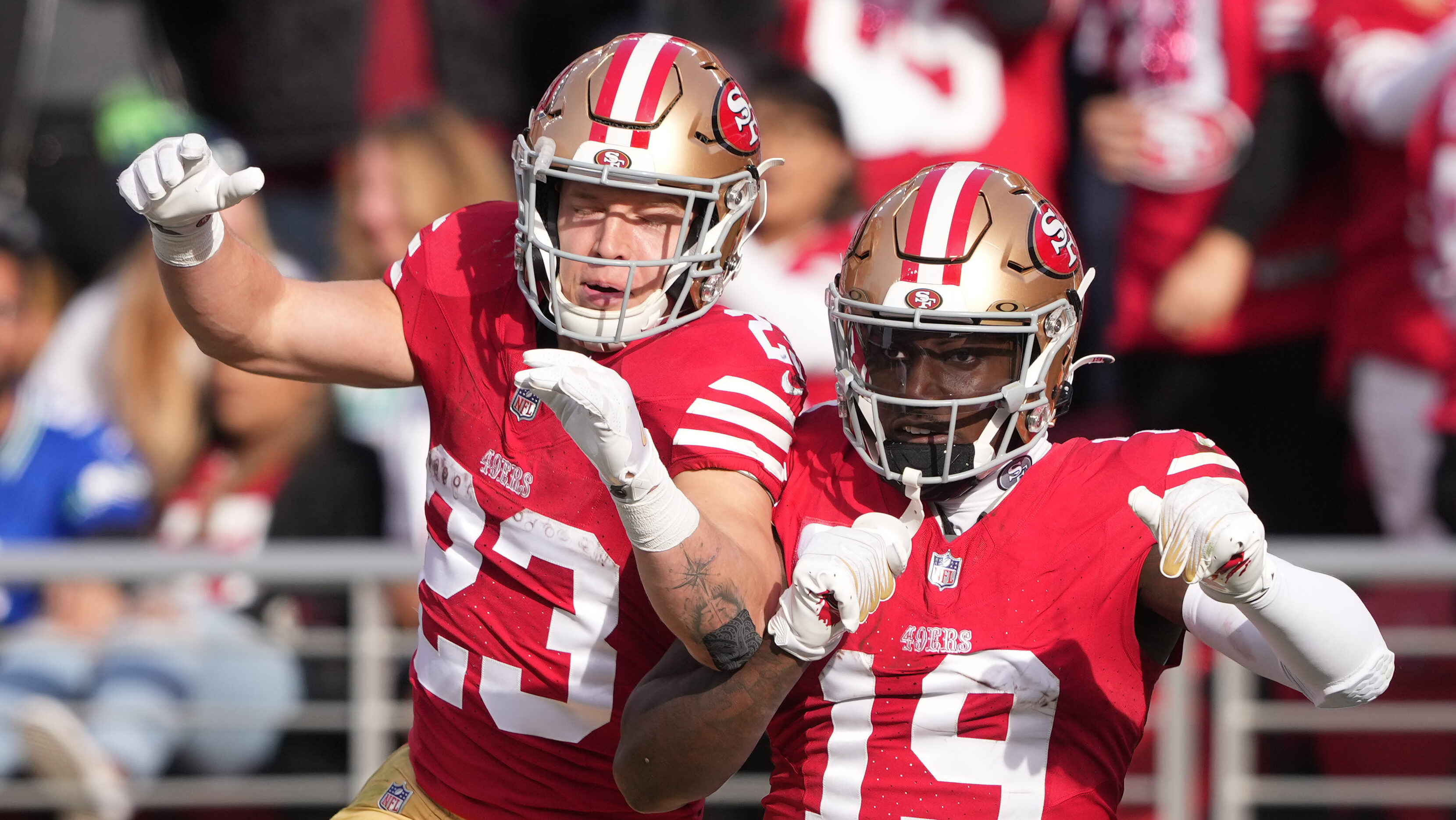 Christian McCaffrey and Deebo Samuel celebrate together.