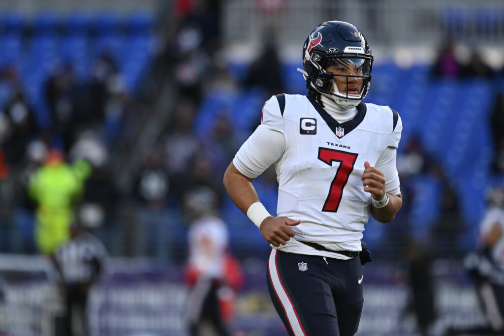 C.J. Stroud jogs onto the field in a white Houston Texans uniform