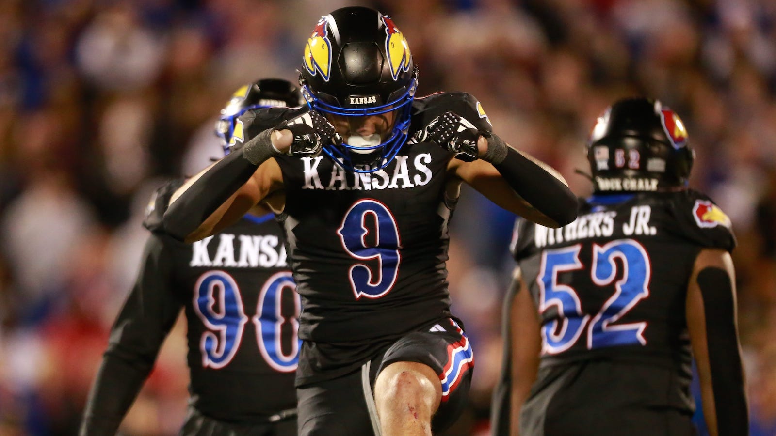 Kansas defensive end Austin Booker celebrates a sack