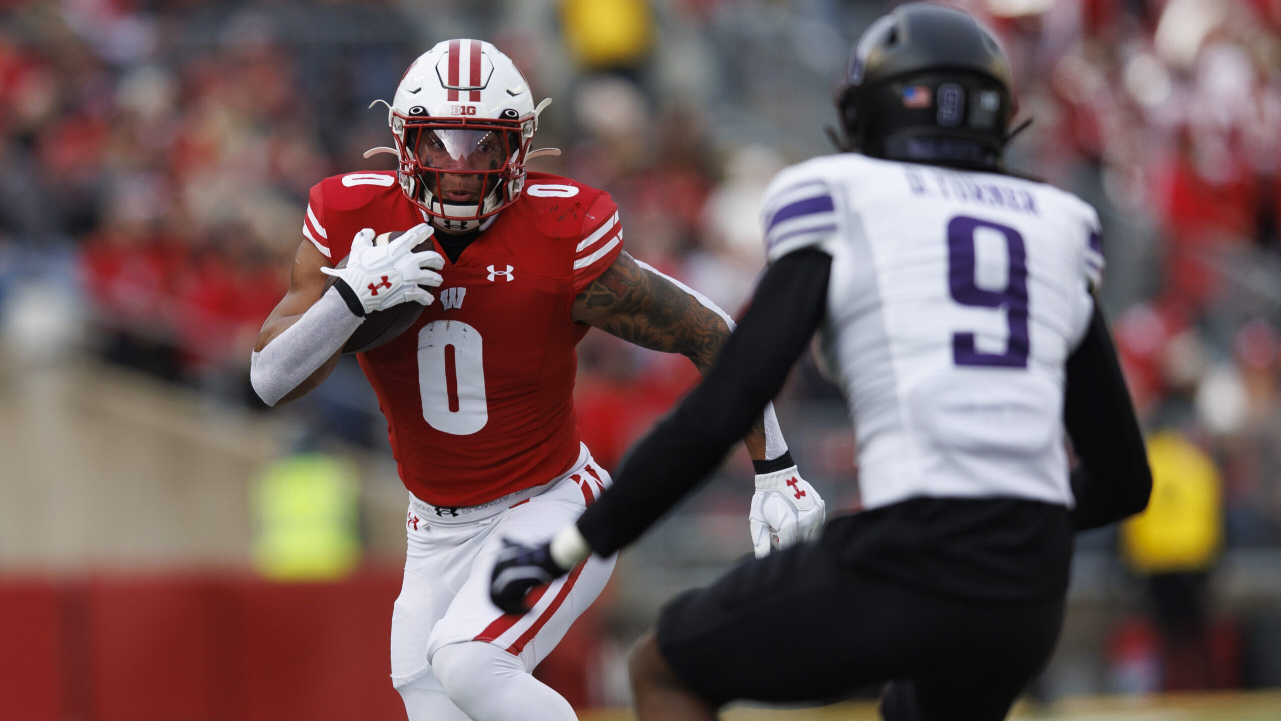 Wisconsin running back Braelon Allen runs toward a Northwestern defender