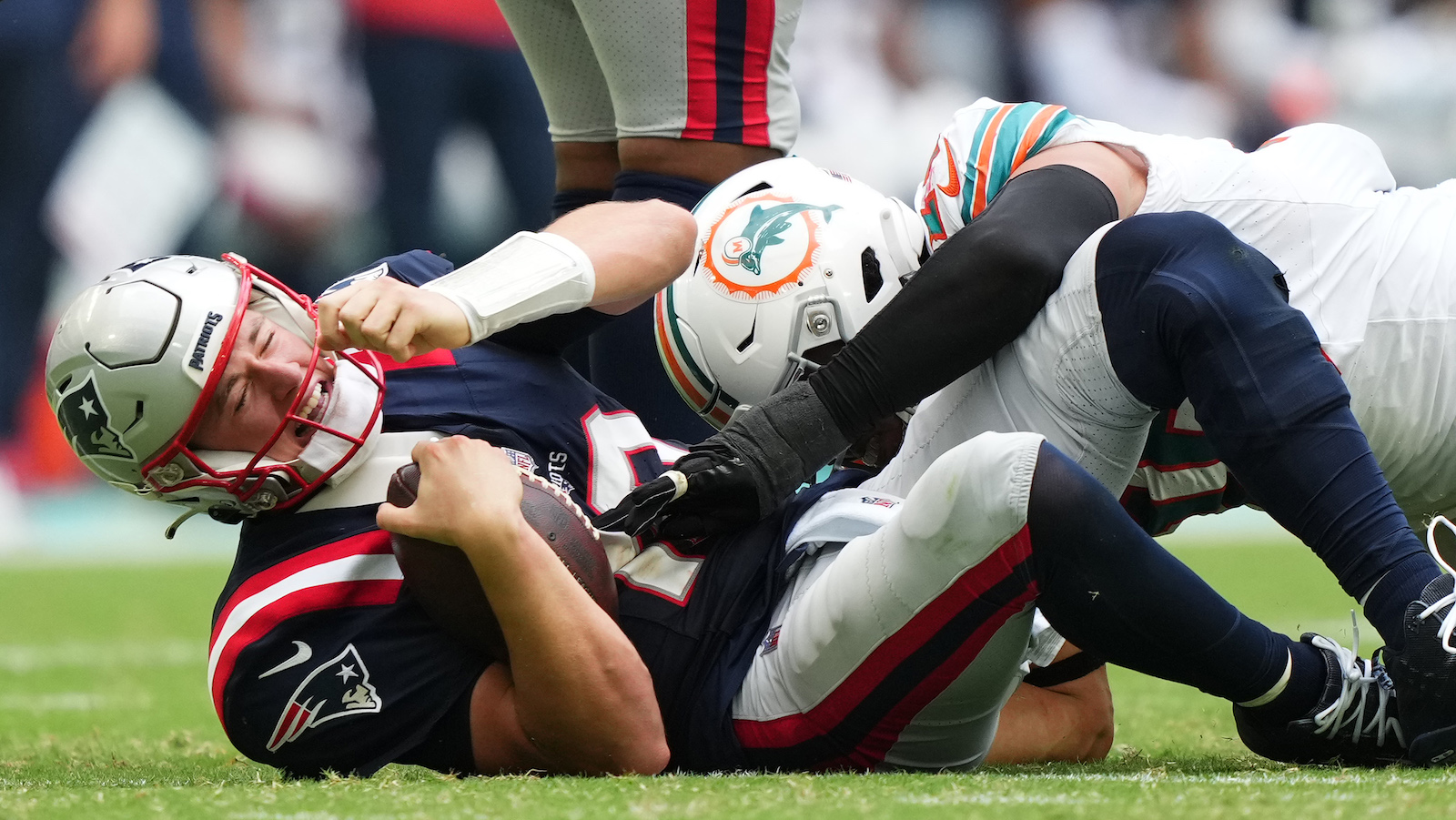 Patriots quarterback Mac Jones is sacked by the Dolphins' Jaelan Phillips