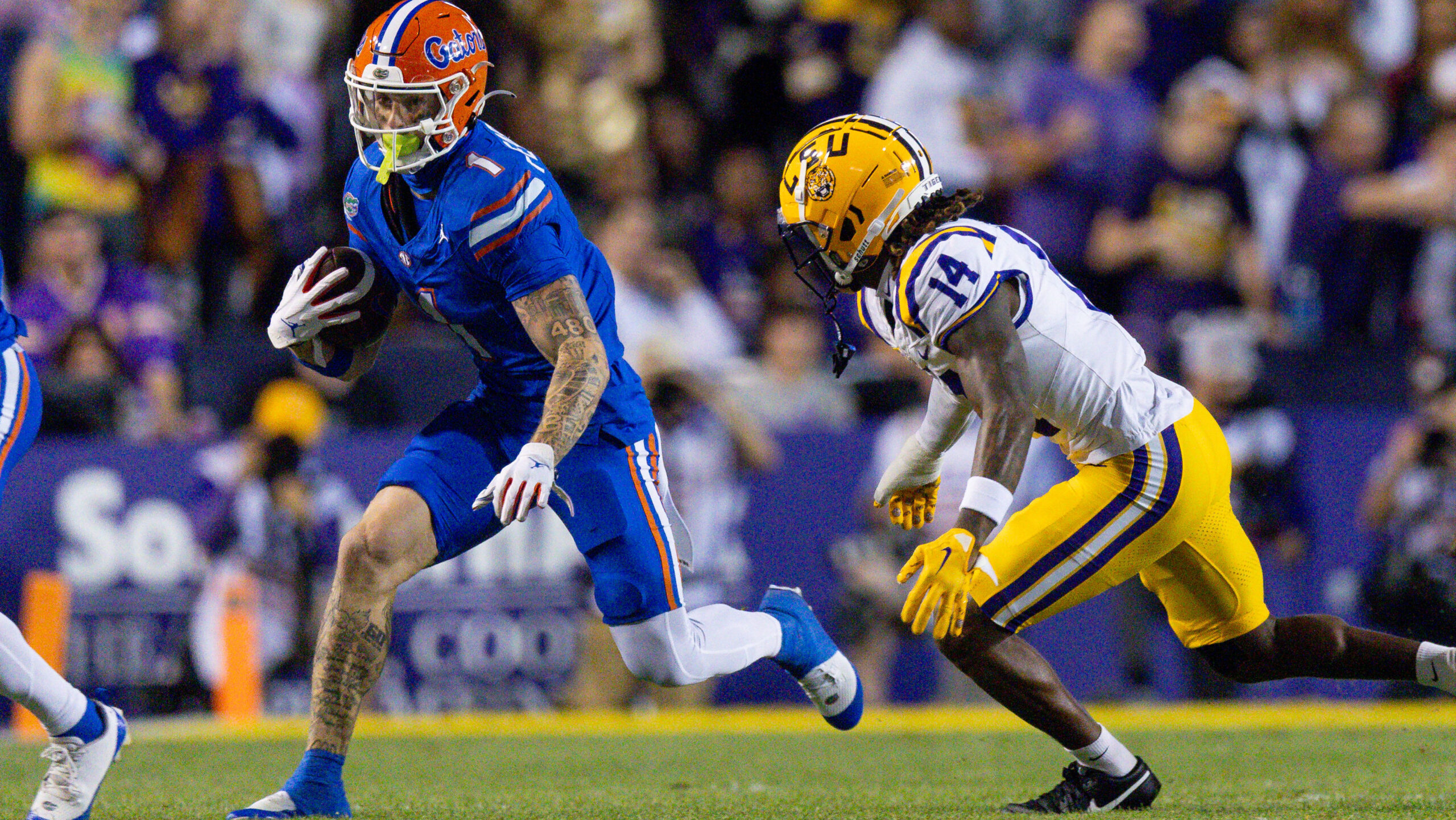 Florida wide recevier Ricky Pearsall runs away from LSU defender.