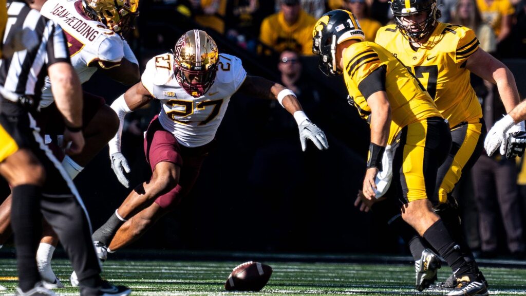 Minnesota safety Tyler Nubin recovers a fumble against Iowa
