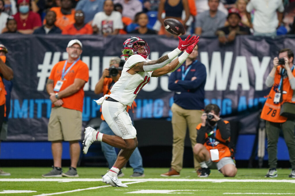 Malachi Corley stretches to catch the football