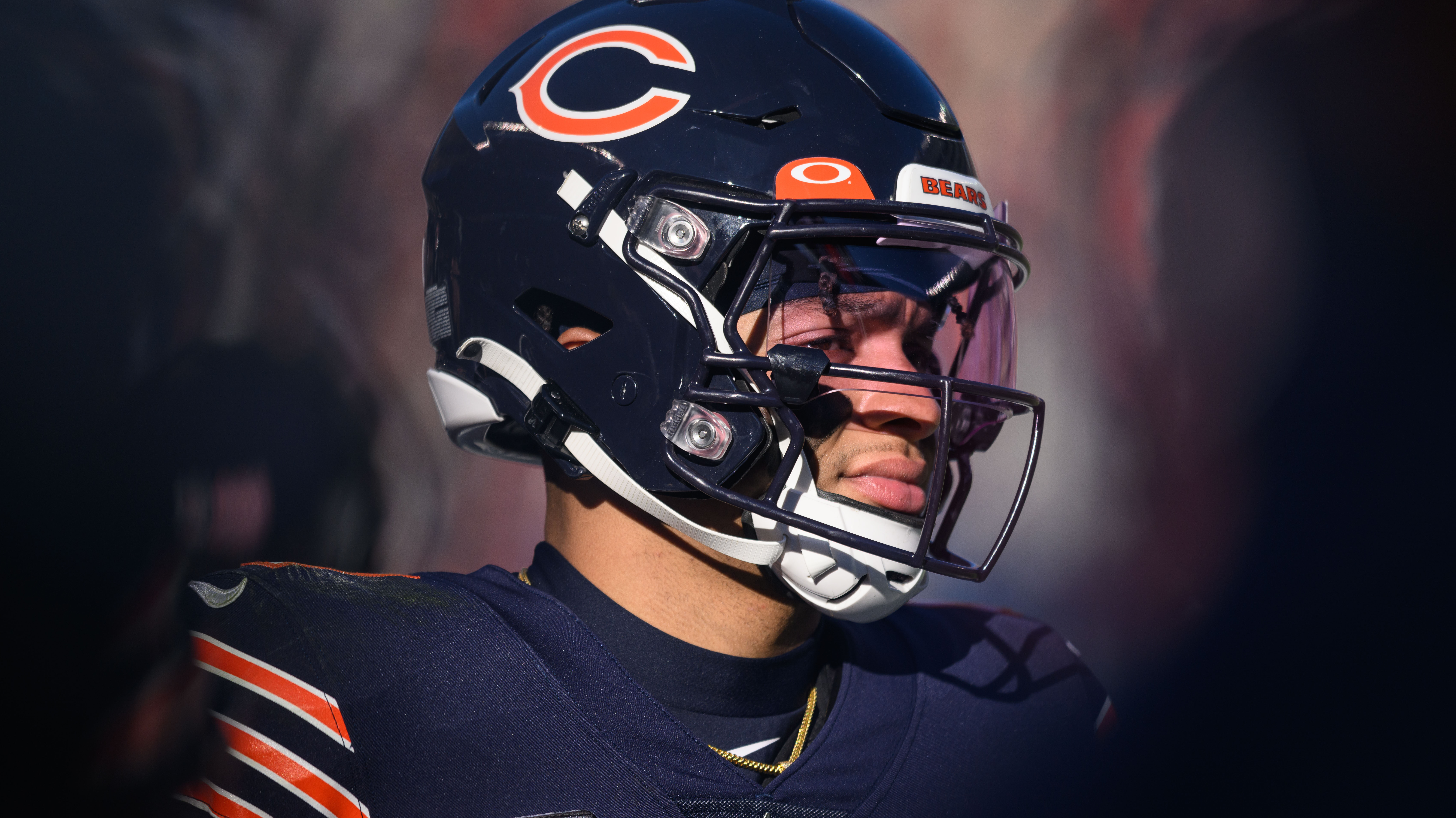Bears QB Justin Fields looks to his left with his helmet on
