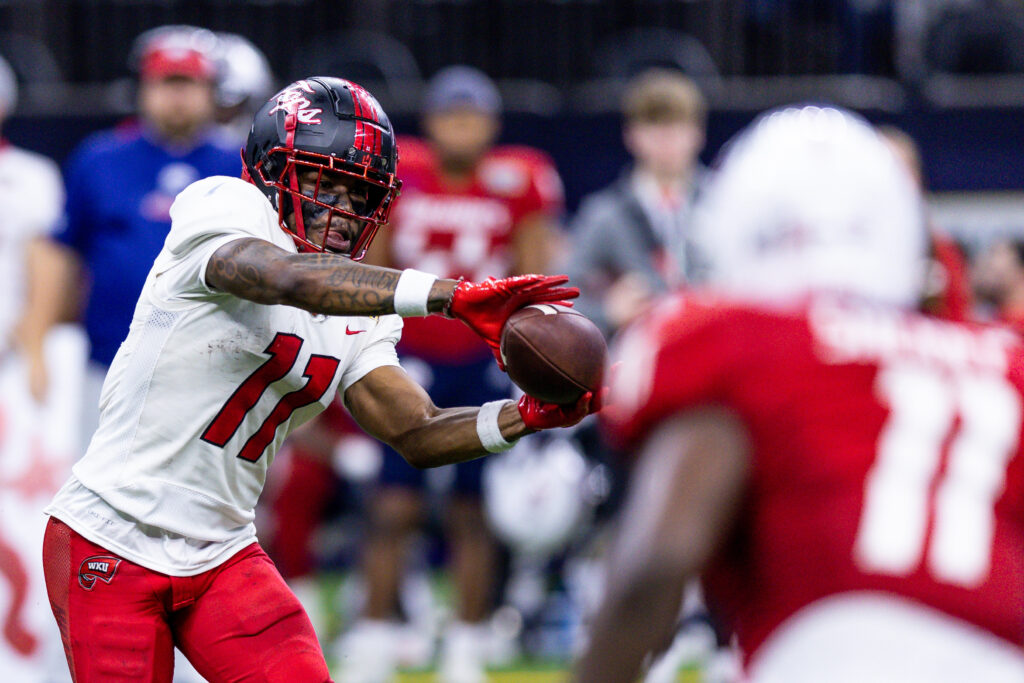 Malachi Corley catches a football