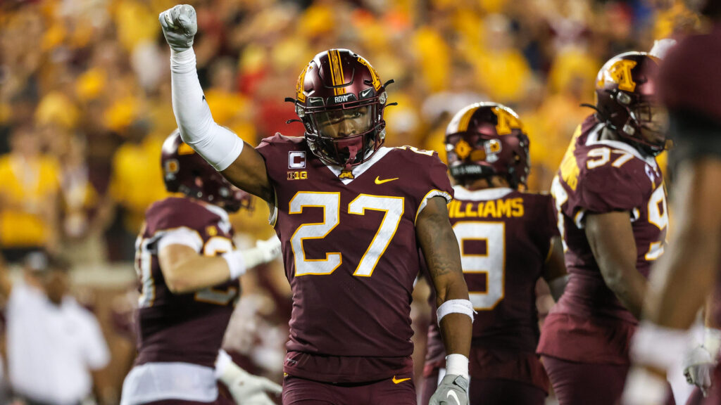 Minnesota safety Tyler Nubin holds up first, signaling it's fourth down