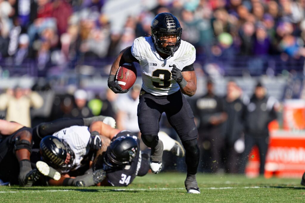 Tyrone Tracy runs in the open field