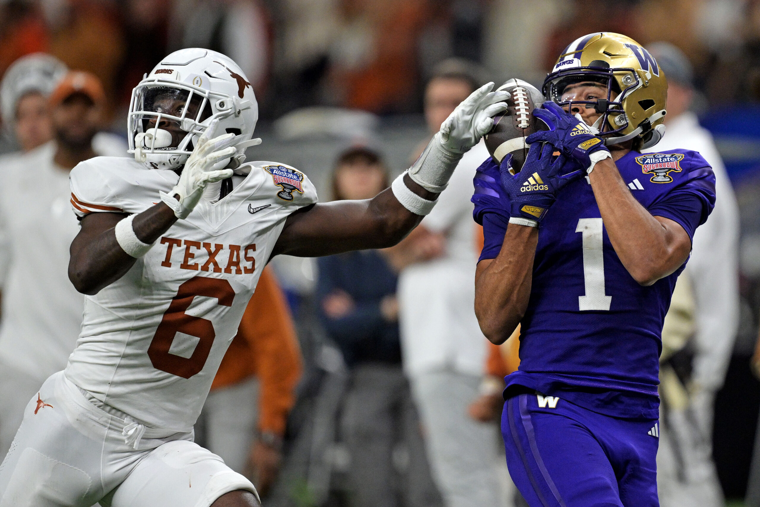 Rome Odunze makes a tough catch with a Texas wide receiver's hands near the ball