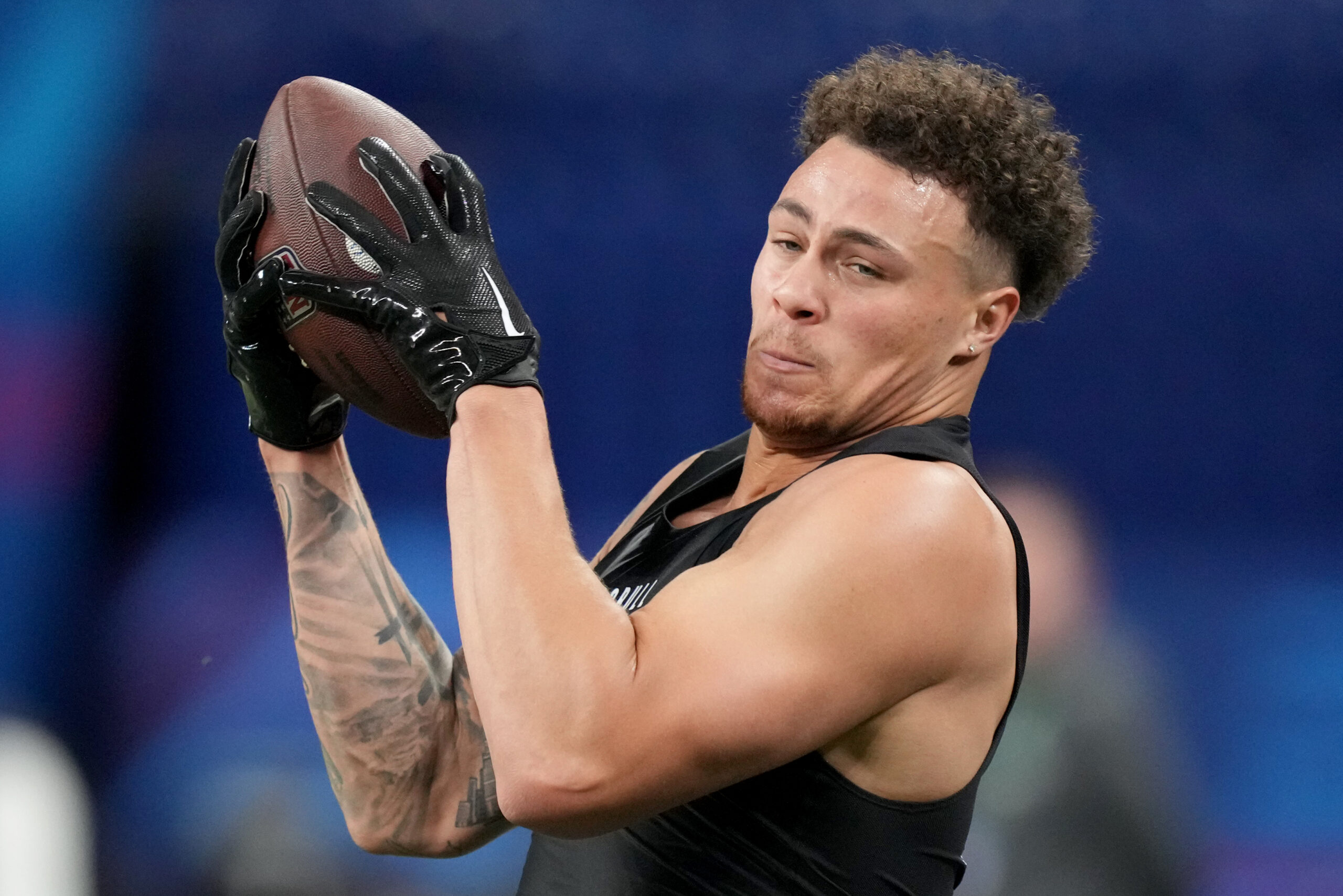 Theo Johnson catches a pass tightly close to his body at the combine