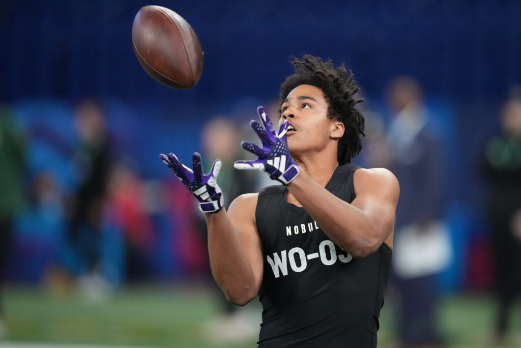 Jalen Coker makes a catch over his right shoulder