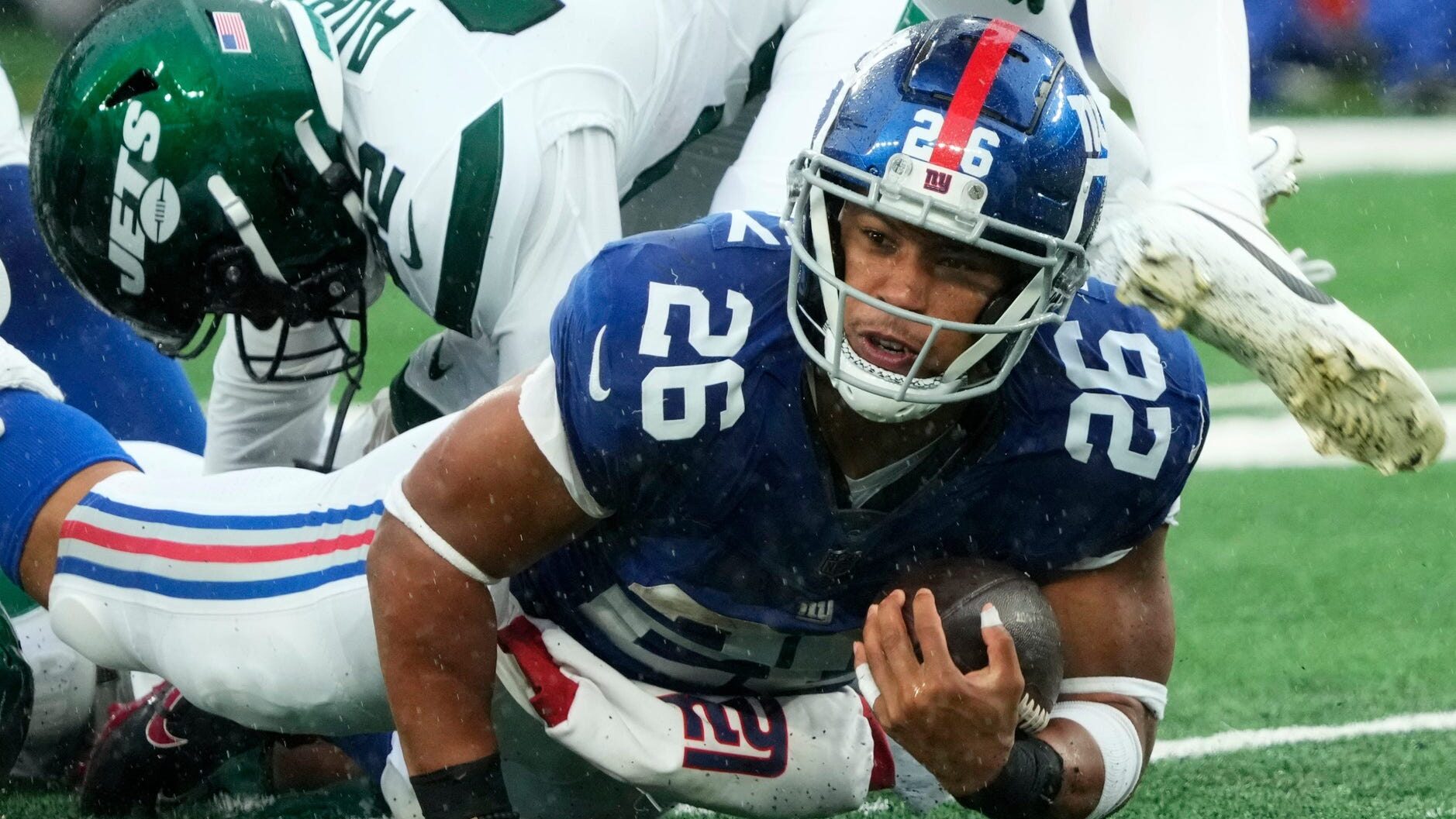 Saquon Barkley goes down after a tackle