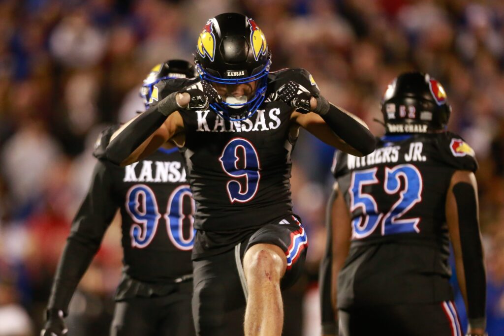 Austin Booker, dressed in all black, celebrates 