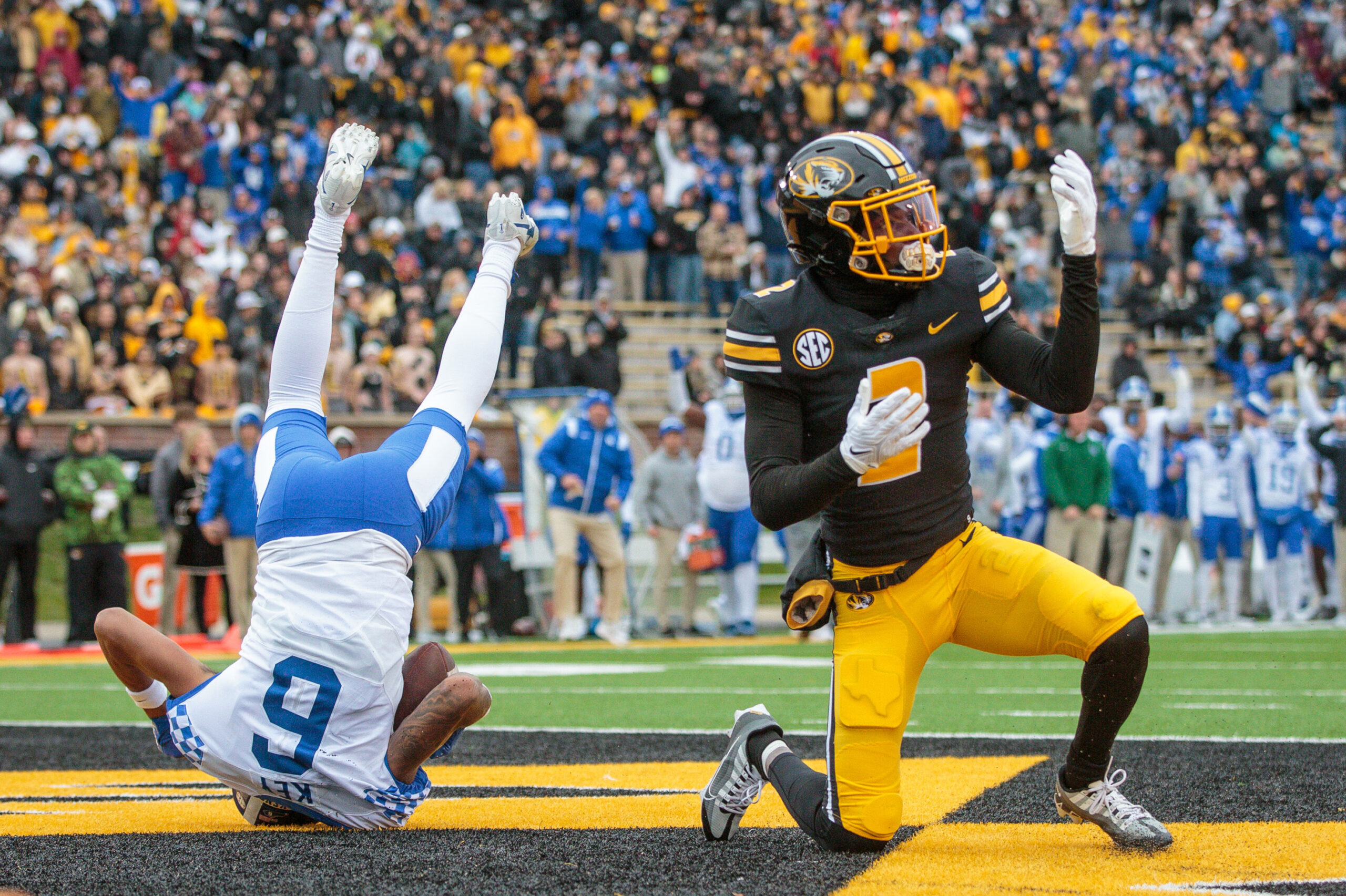 Ennis Rakestraw Jr kneels in the endzone while a Kentucky receiver lands on his head.