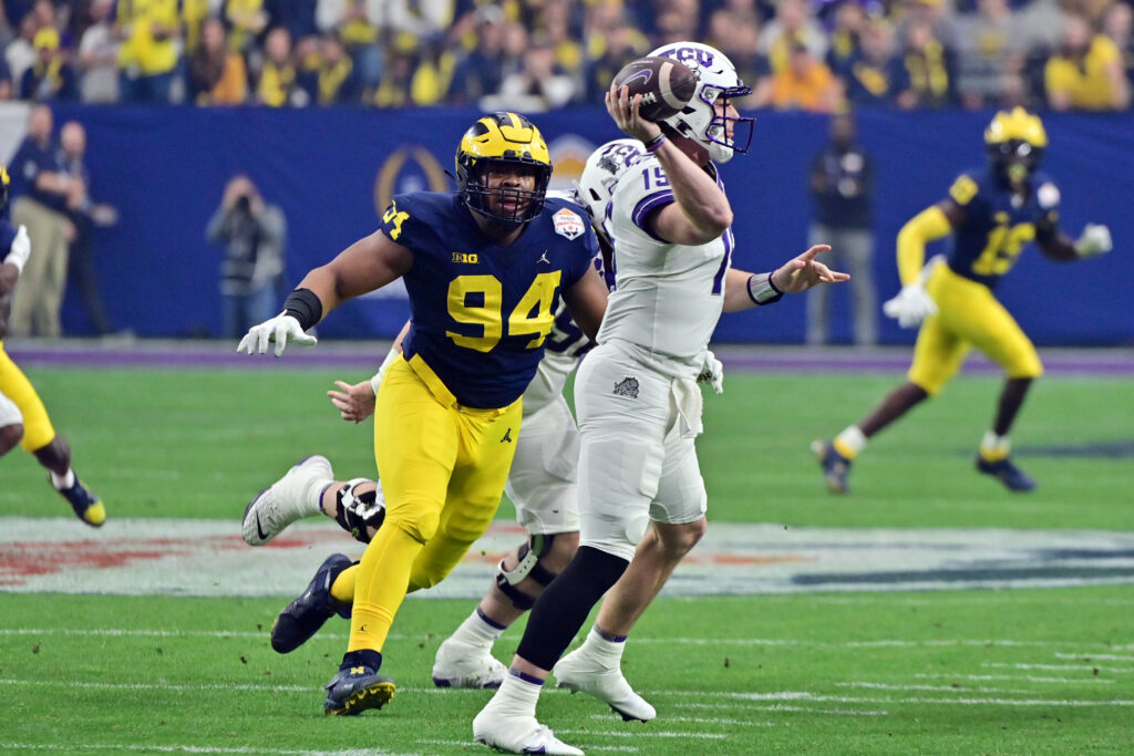 Michigan Wolverines defensive lineman Kris Jenkins beats his man and chases after the TCU quarterback