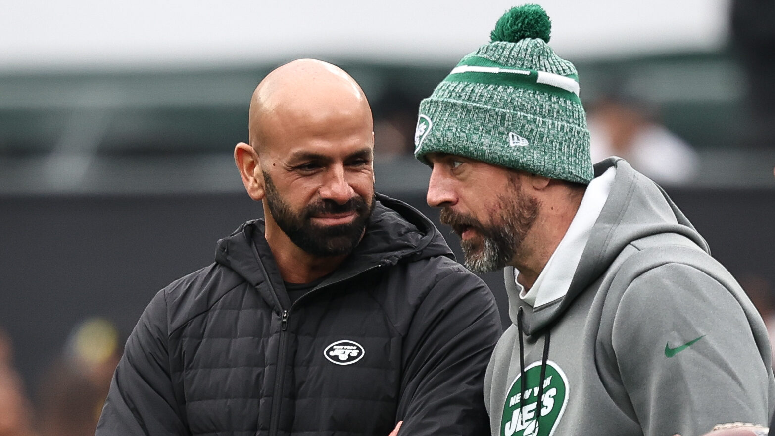 Jets head coach Robert Saleh stands with QB Aaron Rodgers.