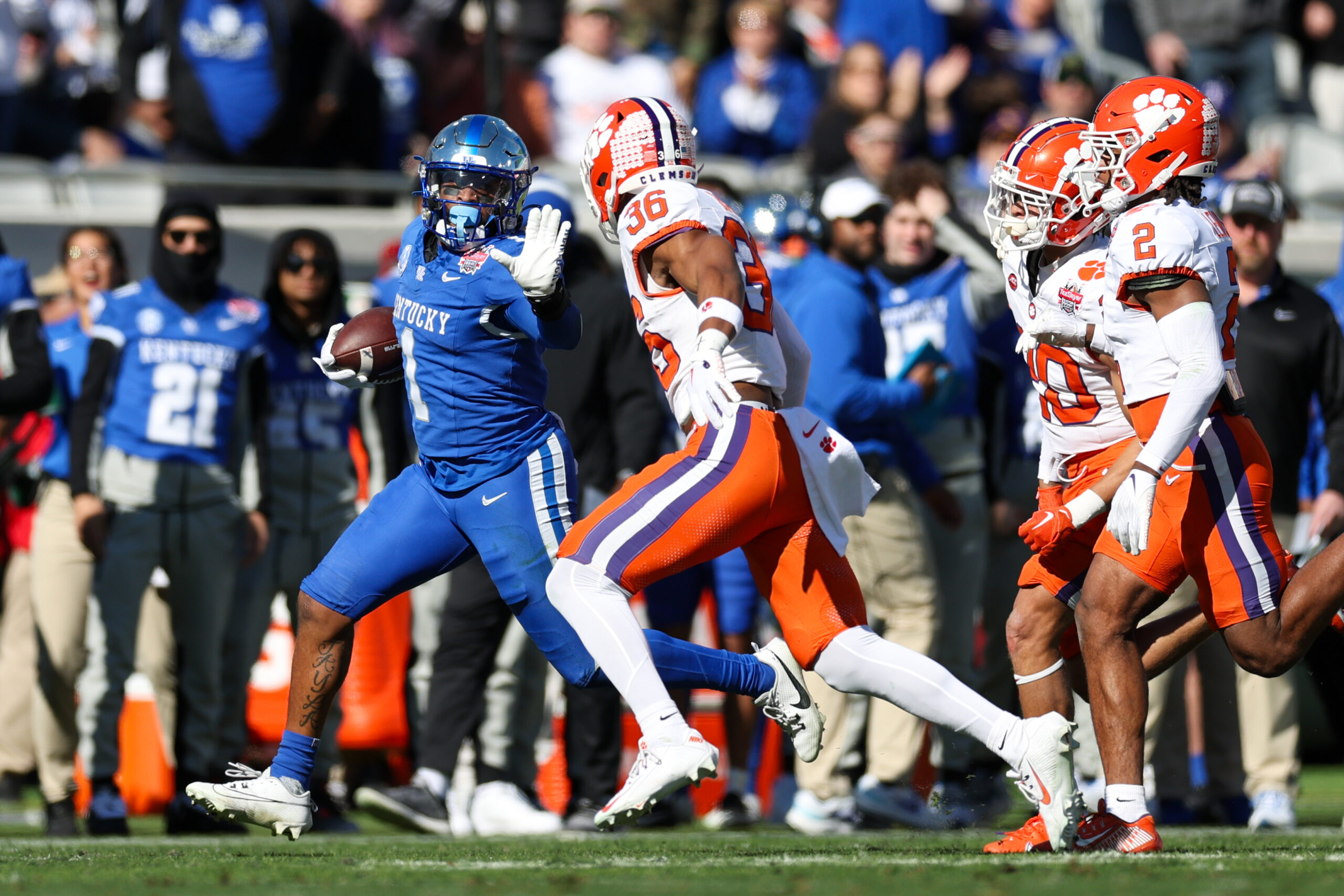 Ray Davis, in all blue, runs away from a defender