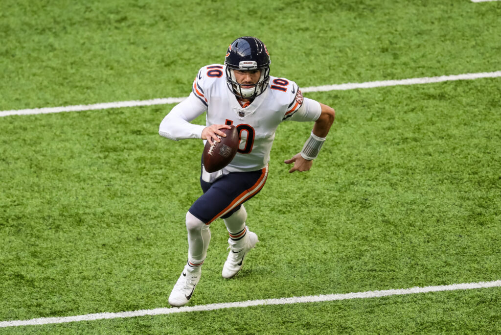 Mitch Trubisky (white jersey, navy pants, navy helmet) runs alone on the field