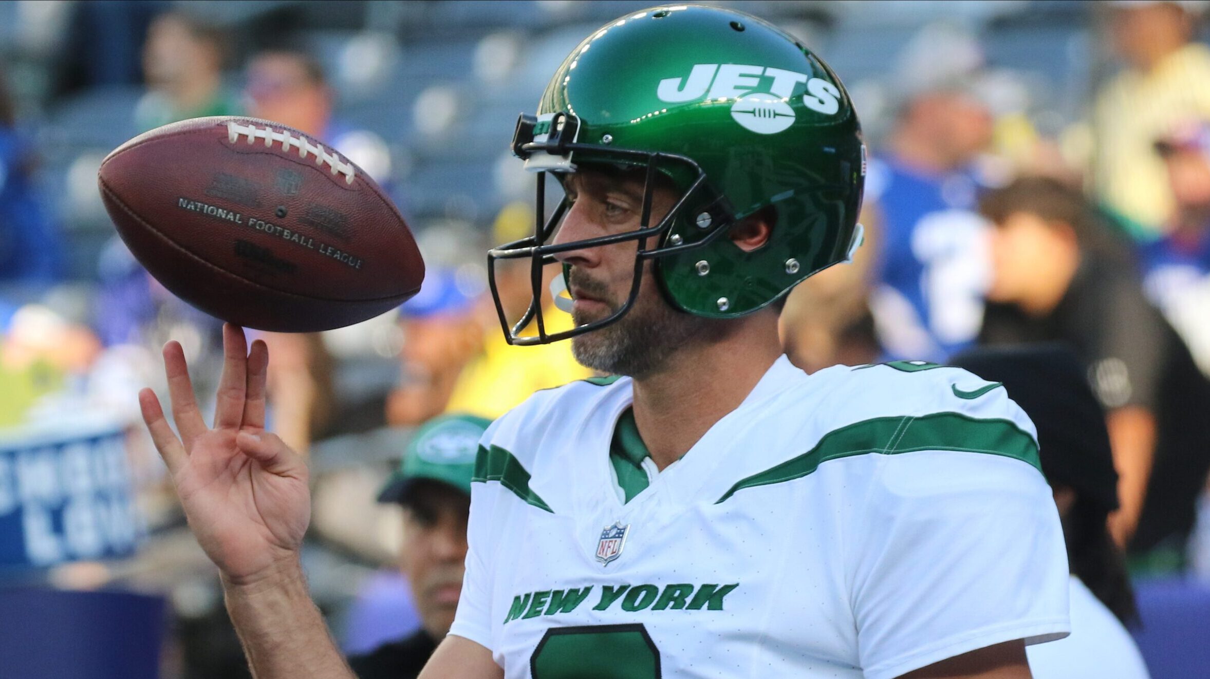 Aaron Rodgers spins a ball on his fingers before the game.