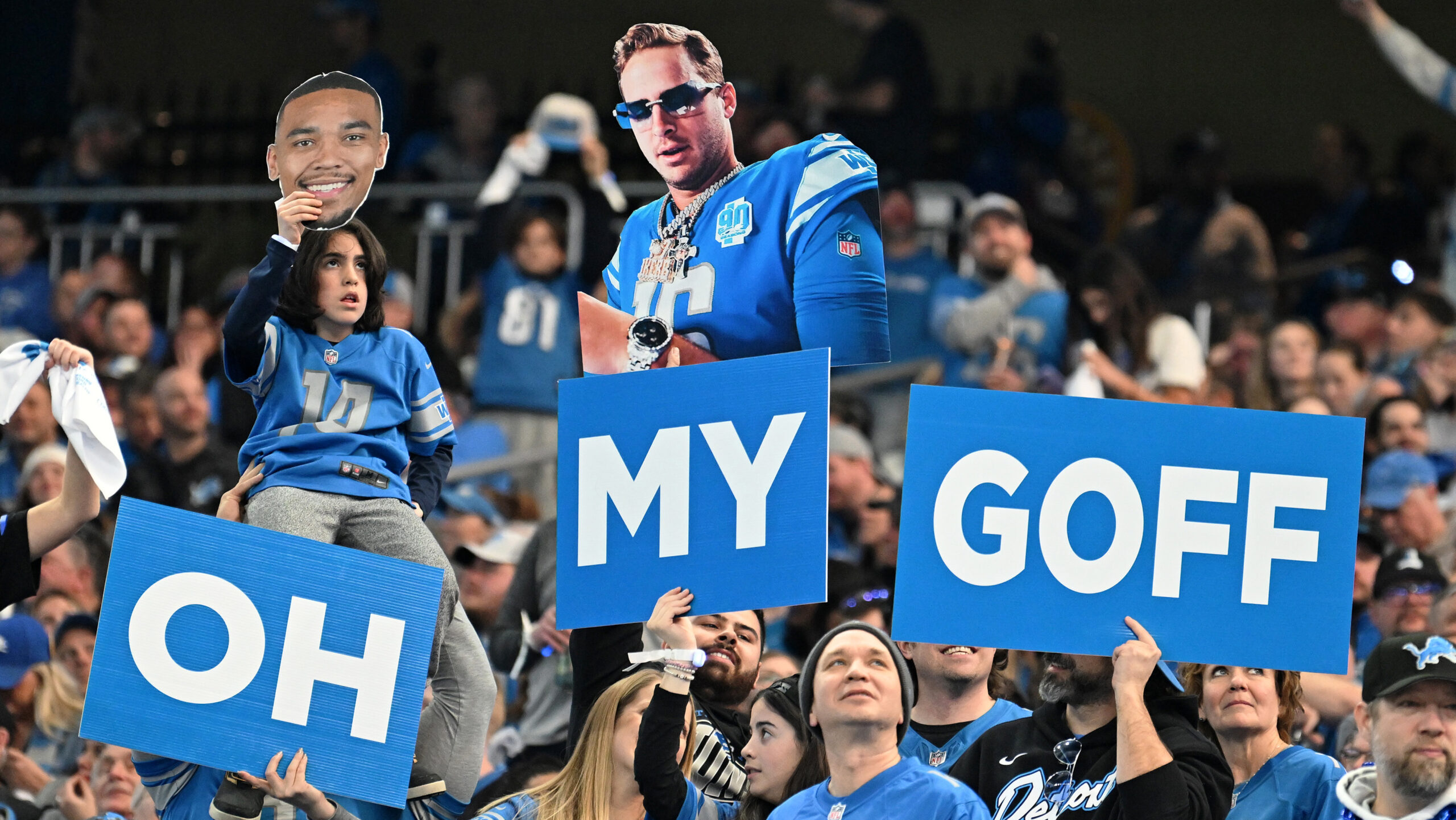 Detroit Lions fans hold up signs saying "Oh my Goff"