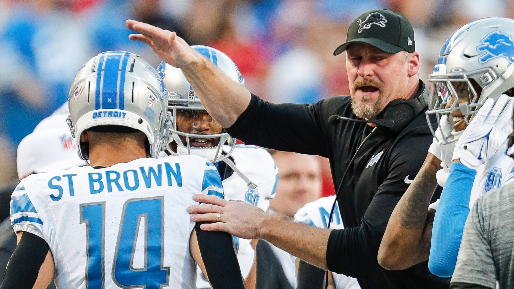 Lions head coach Dan Campbell celebrates a touchdown and welcomes Amon-Ra St. Brown back to the sideline.
