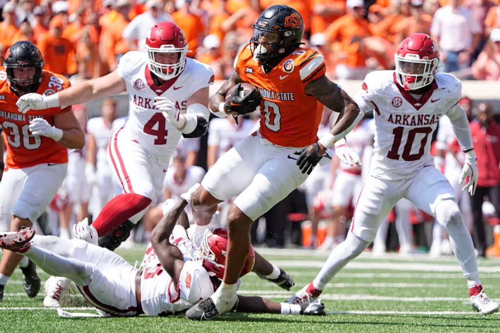 Oklahoma State's Ollie Gordon II rushes in the second half of the college football game between the Oklahoma State Cowboys and the Arkansas Razorbacks at Boone Pickens Stadium