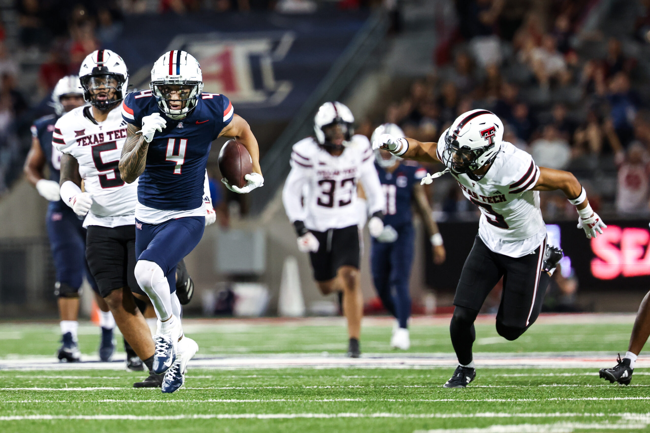 Arizona Wildcats wide receiver Tetairoa McMillan (4) runs with the ball during third quarter against Texas Tech Red Raiders at Arizona Stadium.