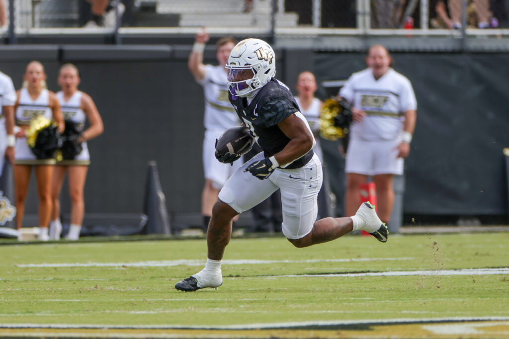 UCF Knights running back RJ Harvey (7) runs the ball during the first quarter against the Cincinnati Bearcats at FBC Mortgage Stadium.