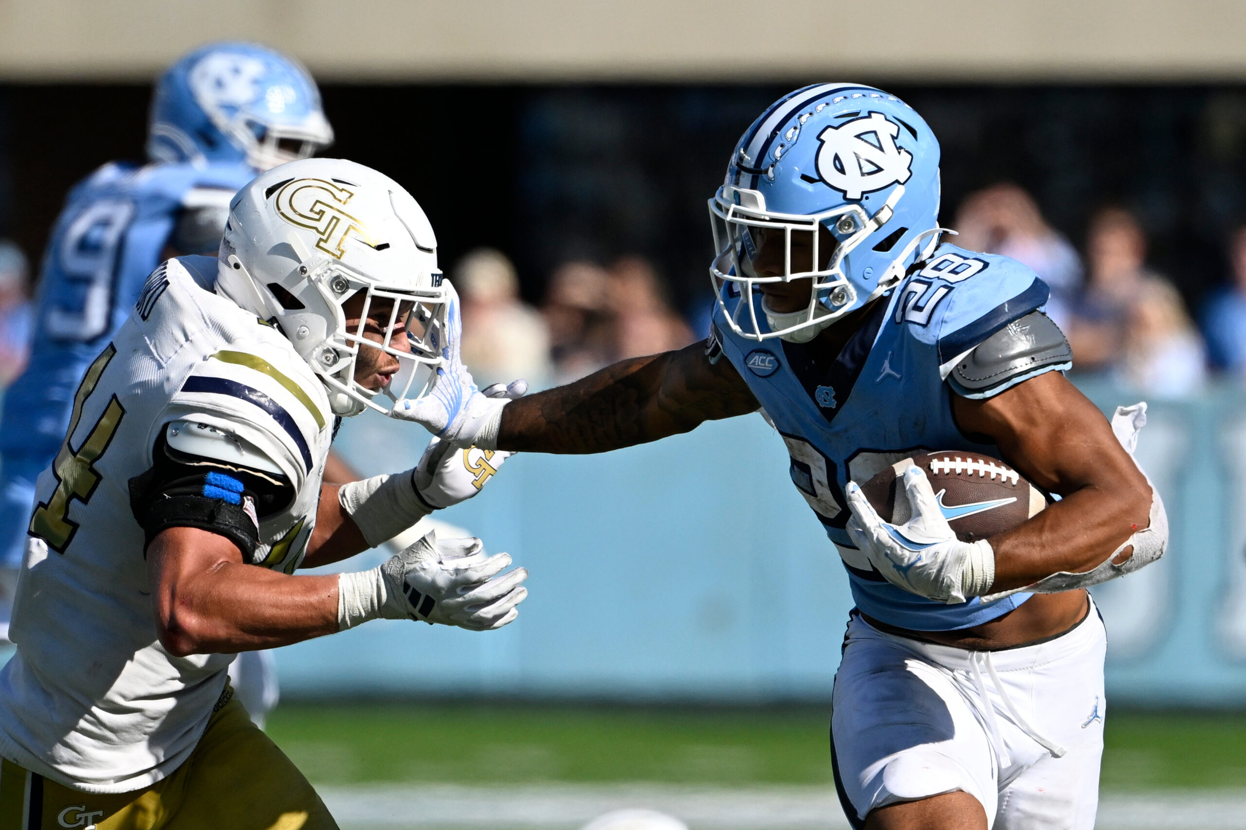 North Carolina Tar Heels running back Omarion Hampton (28) with the ball as Georgia Tech Yellow Jackets linebacker Kyle Efford (44) defends in the fourth quarter at Kenan Memorial Stadium.