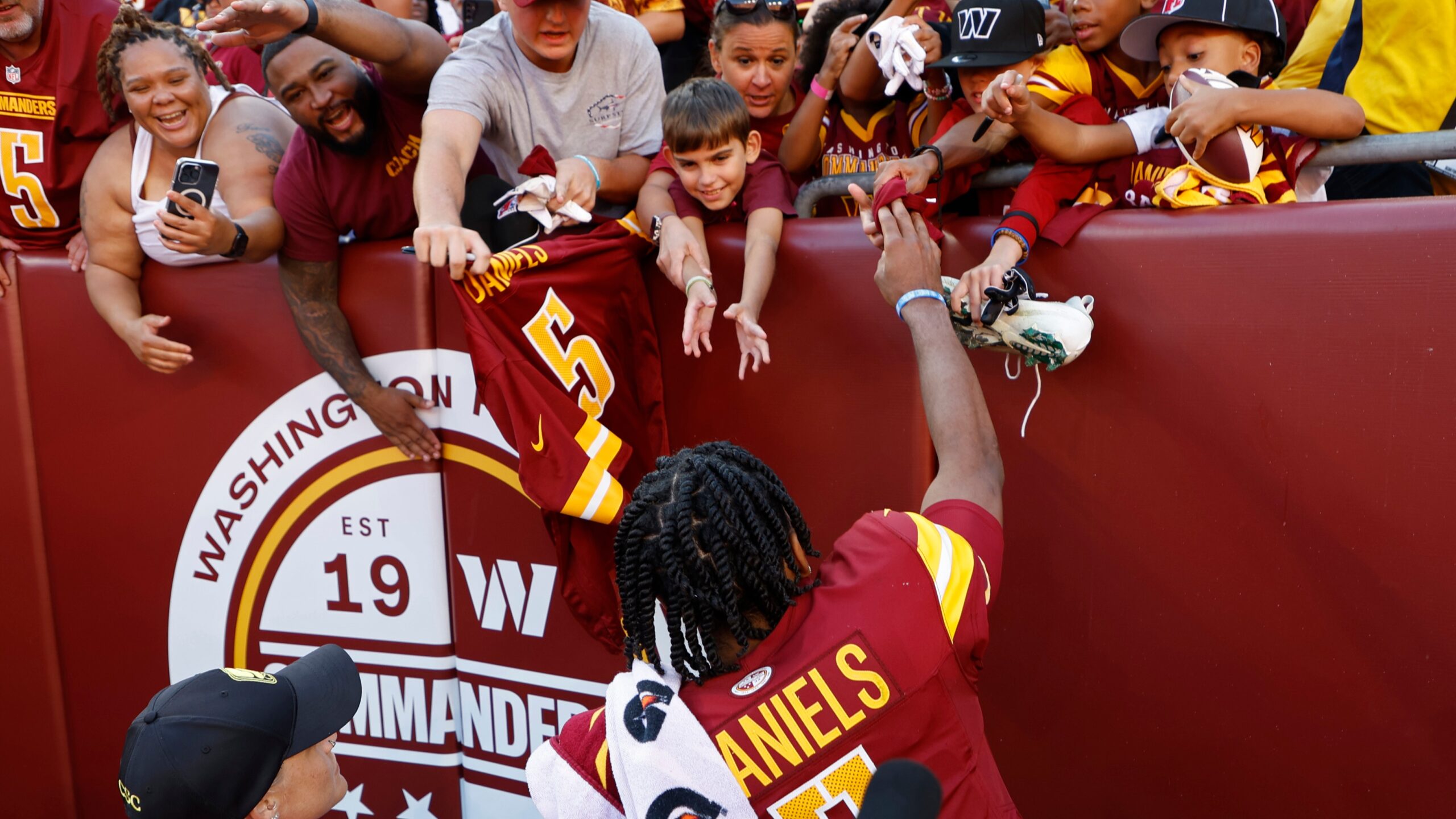Jayden Daniels interacts with fans after the win