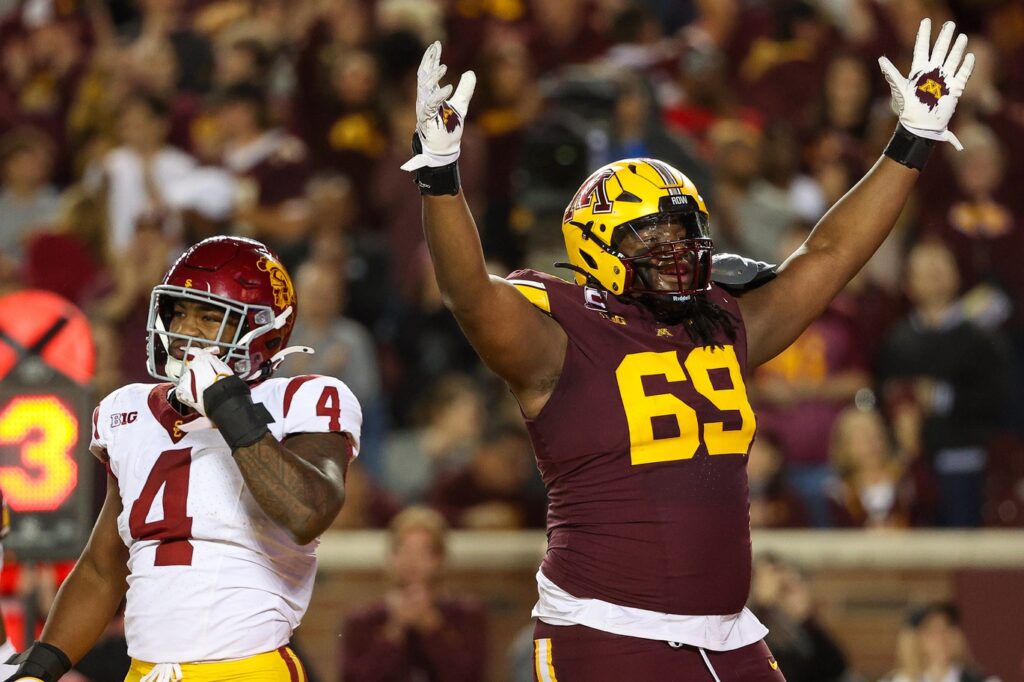 Minnesota Golden Gophers offensive lineman Aireontae Ersery celebrates quarterback Max Brosmer's touchdown against USC.