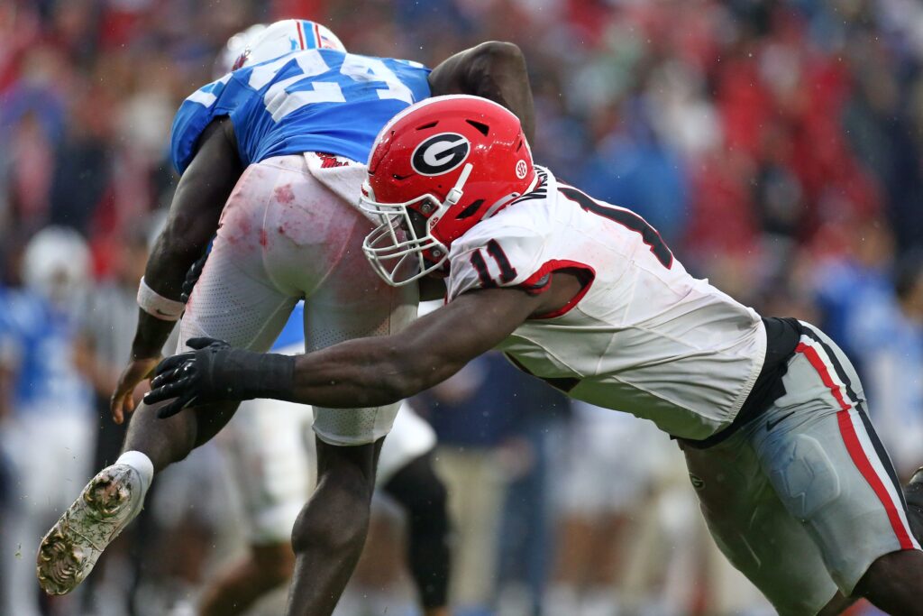 Georgia Bulldogs linebacker Jalon Walker tackles Mississippi Rebels running back Ulysses Bentley IV during college football game action at Vaught-Hemingway Stadium