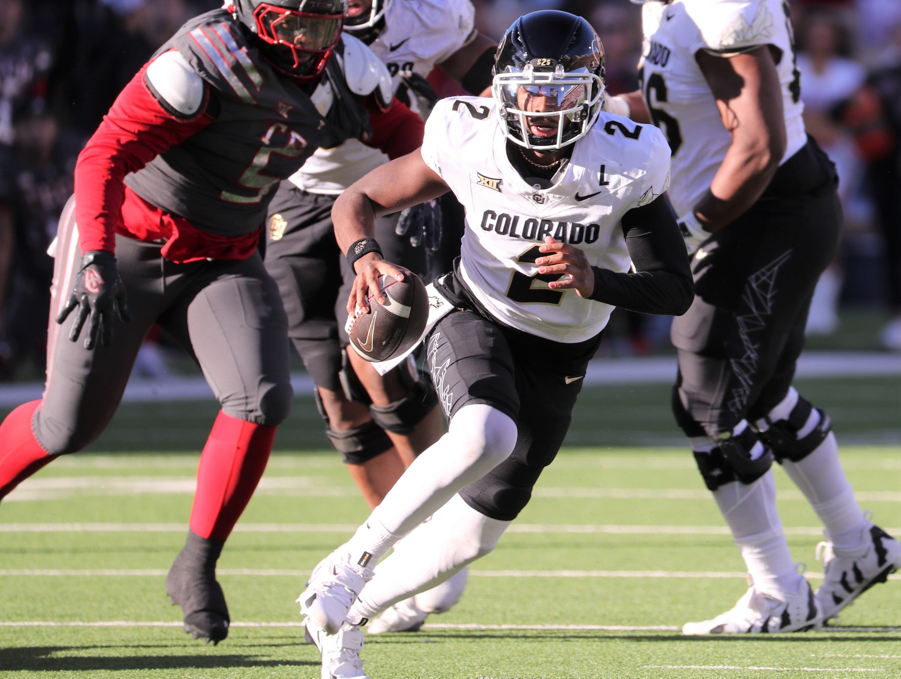 Colorado's Shedeur Sanders scrambles against Texas Tech in Big 12 football game action at Jones AT&T Stadium
