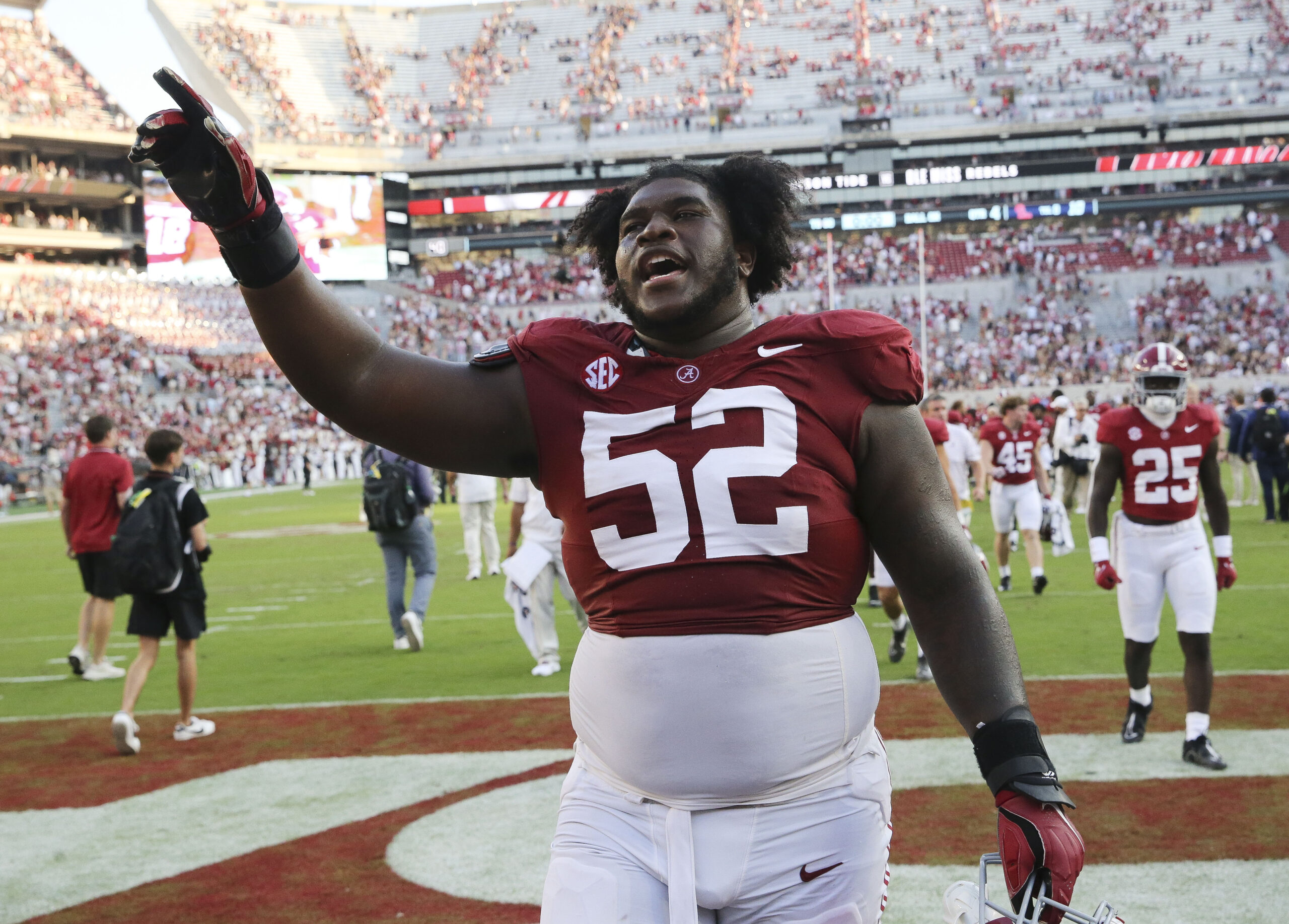 Alabama Crimson Tide offensive lineman Tyler Booker (52) celebrates as he leaves the field at Bryant-Denny Stadium.