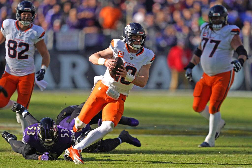 Denver Broncos quarterback Bo Nix runs for a gain in the second quarter against the Baltimore Ravens at M&T Bank Stadium.