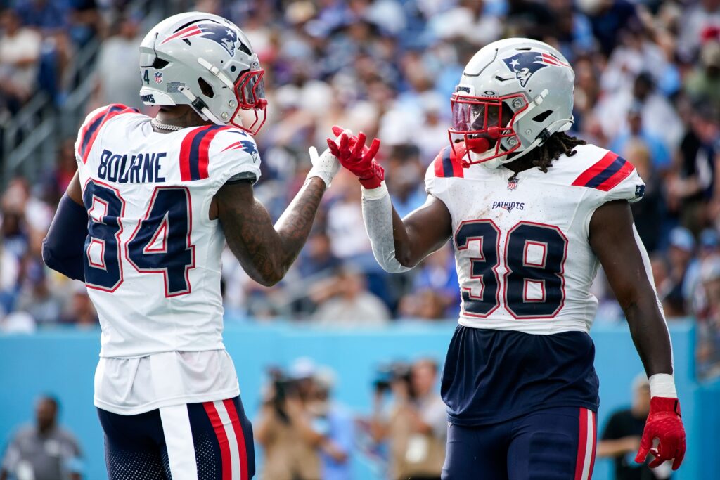 New England Patriots running back Rhamondre Stevenson celebrates his touchdown against the Tennessee Titans with wide receiver Kendrick Bourne.
