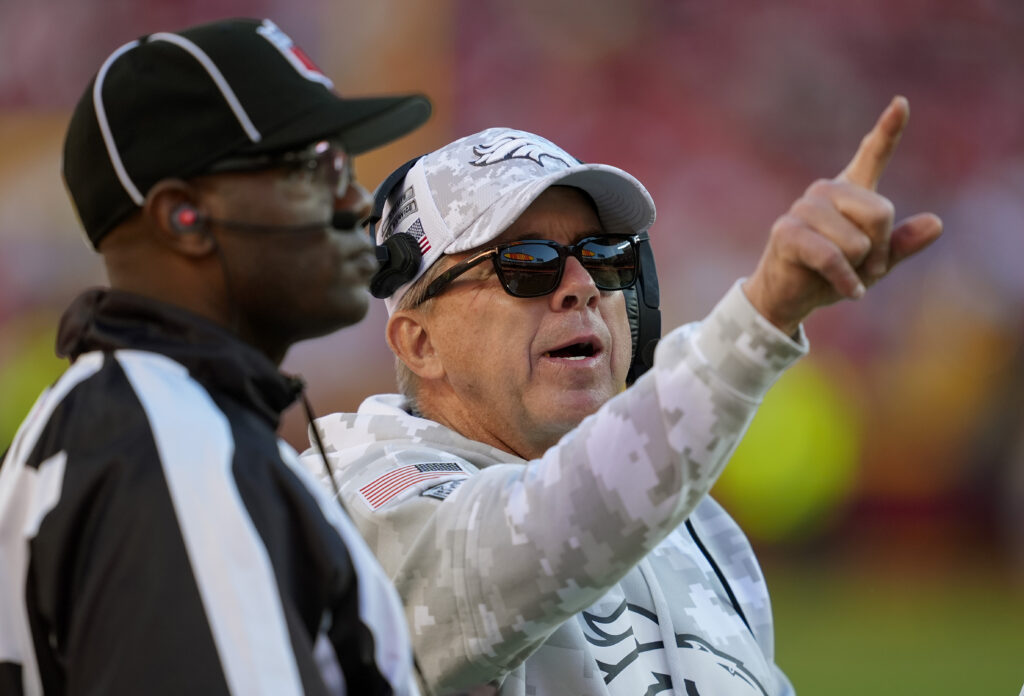Denver Broncos head coach Sean Payton talks to line judge Jeff Bergman during the second half against the Kansas City Chiefs at GEHA Field at Arrowhead Stadium.