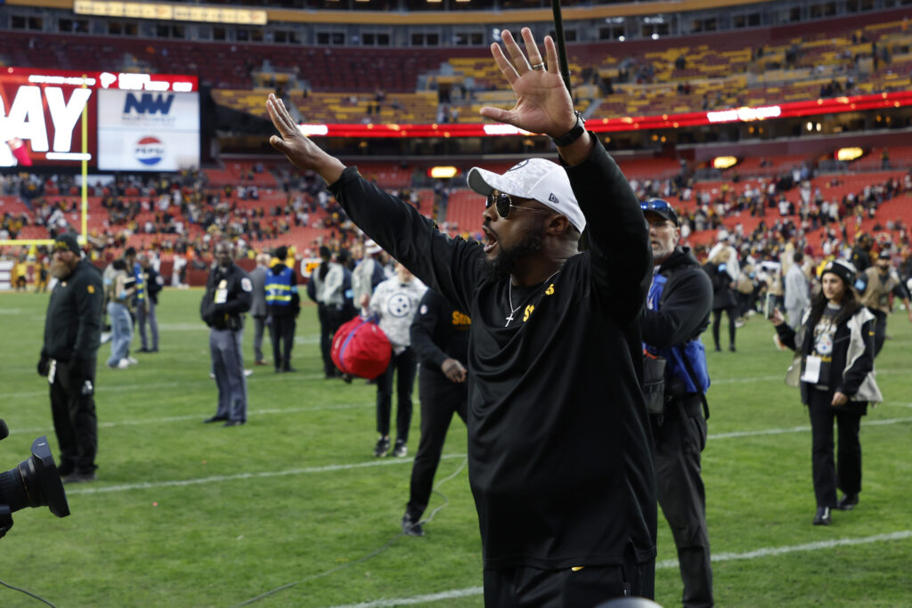 Pittsburgh Steelers head coach Mike Tomlin celebrates while leaving the field after the Steelers' game against the Washington Commanders at Northwest Stadium. 