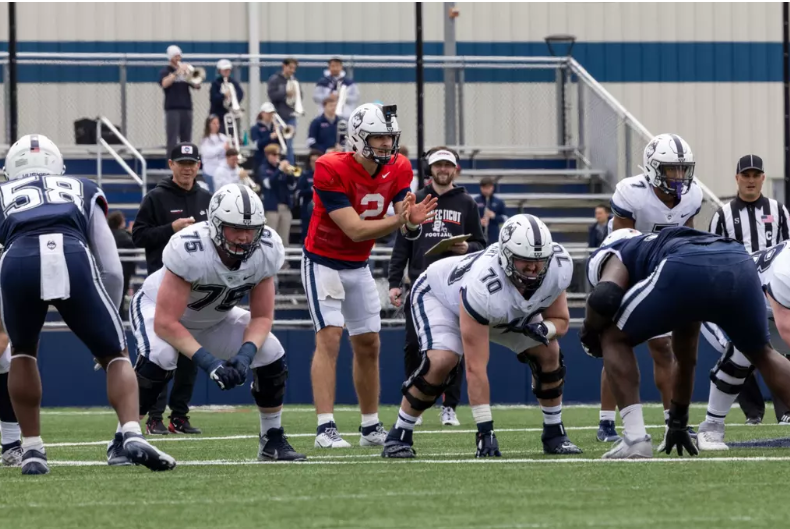 UConn offensive tackle Chase Lundt lines up before a snap.