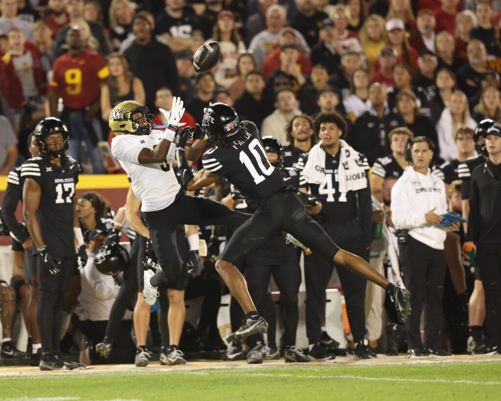 UCF Knights wide receiver Ja'Varrius Johnson (9) and Iowa State Cyclones defensive back Darien Porter (10) battle for a pass at Jack Trice Stadium.