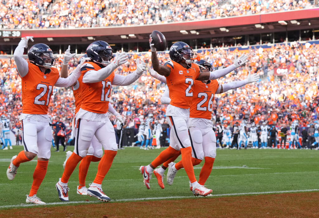 Denver Broncos cornerback Pat Surtain II (2) celebrates his interception with cornerback Riley Moss (21) and linebacker Kwon Alexander (12) and safety Devon Key (26) in the third quarter against the Carolina Panthers.