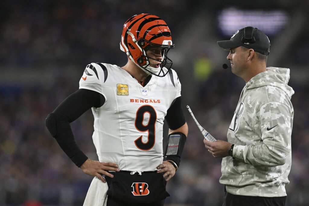 Cincinnati Bengals quarterback Joe Burrow (9) speaks with Cincinnati Bengals head coach Zac Taylor during the first quarter against the Baltimore Ravens at M&T Bank Stadium.