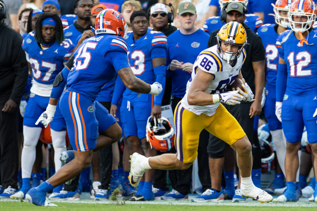 Florida Gators linebacker Derek Wingo (15) looks to tackle LSU Tigers tight end Mason Taylor (86) during the first half at Ben Hill Griffin Stadium.