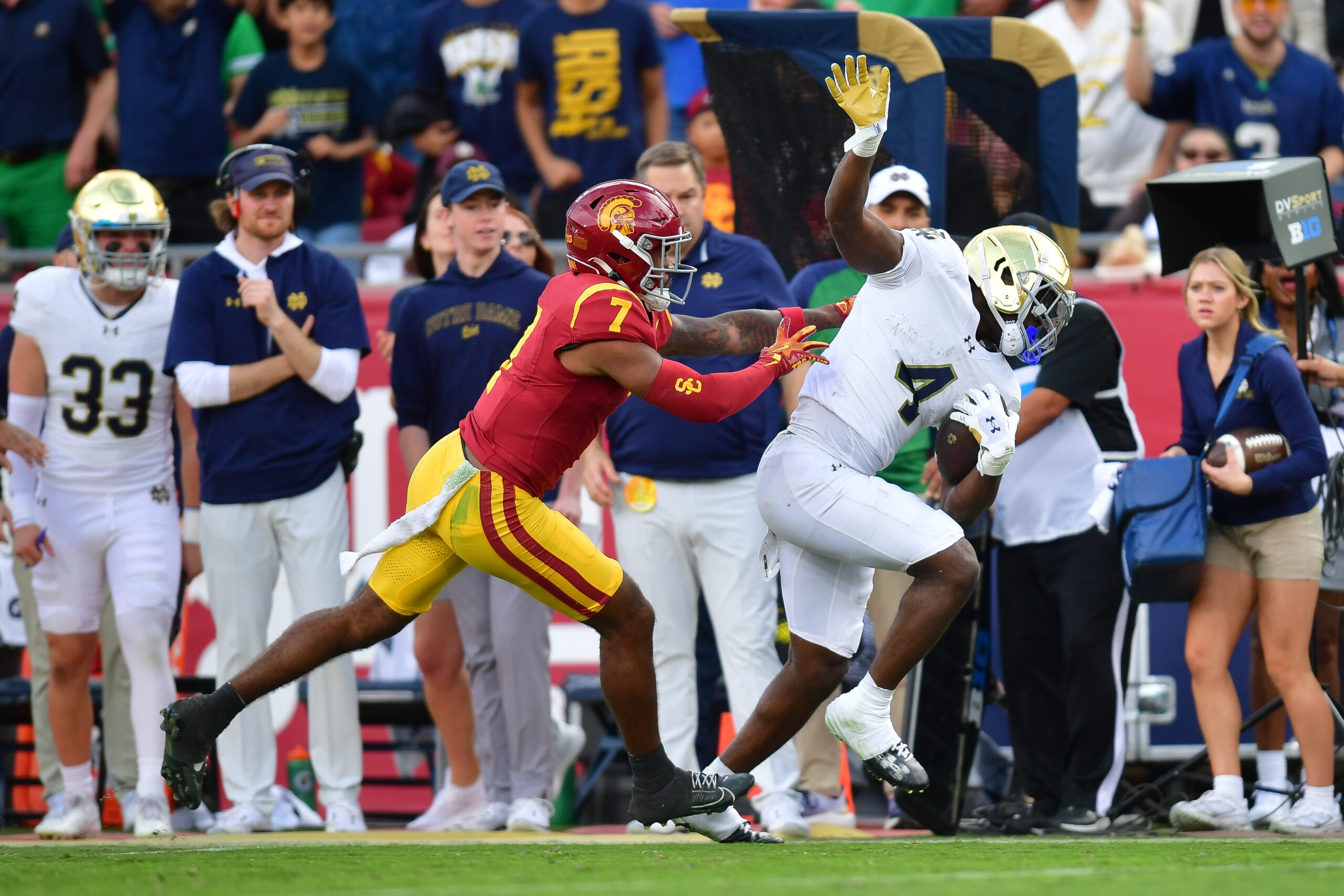 Notre Dame Fighting Irish running back Jeremiyah Love (4) runs the ball against Southern California Trojans safety Kamari Ramsey (7) during the first half at the Los Angeles.