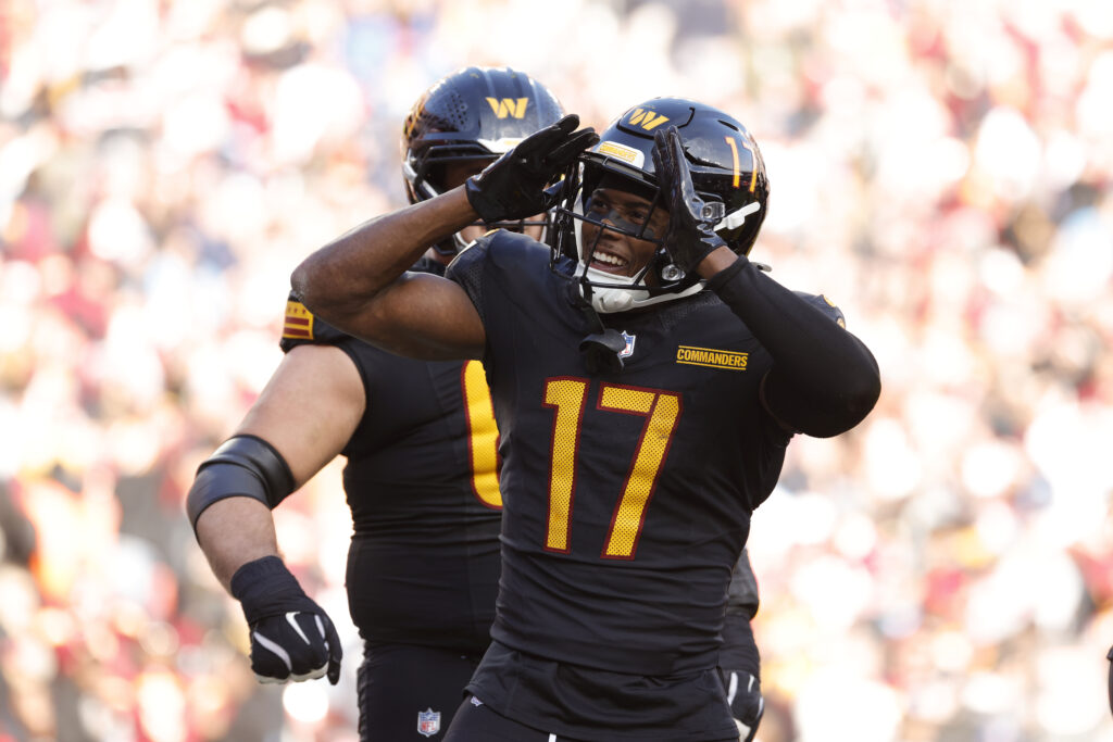 Washington Commanders wide receiver Terry McLaurin (17) celebrates with fans in the stands after scoring a touchdown against Tennessee Titans during the first half at Northwest Stadium.