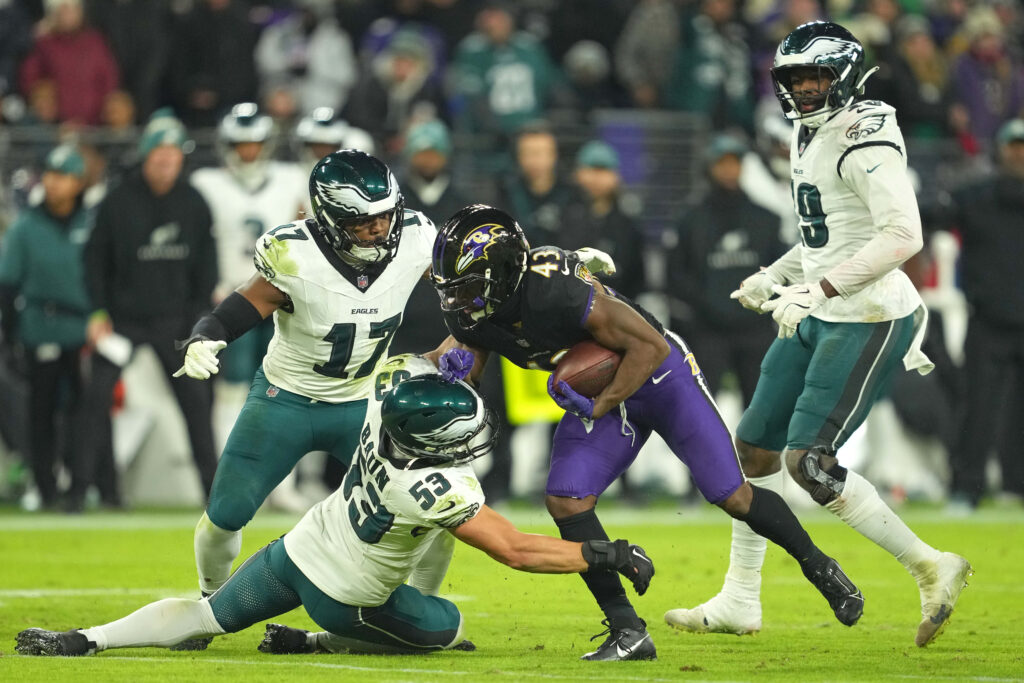 Baltimore Ravens running back Justice Hill (43) runs for a third quarter gain defended by Philadelphia Eagles linebacker Zack Baun (53) at M&T Bank Stadium.