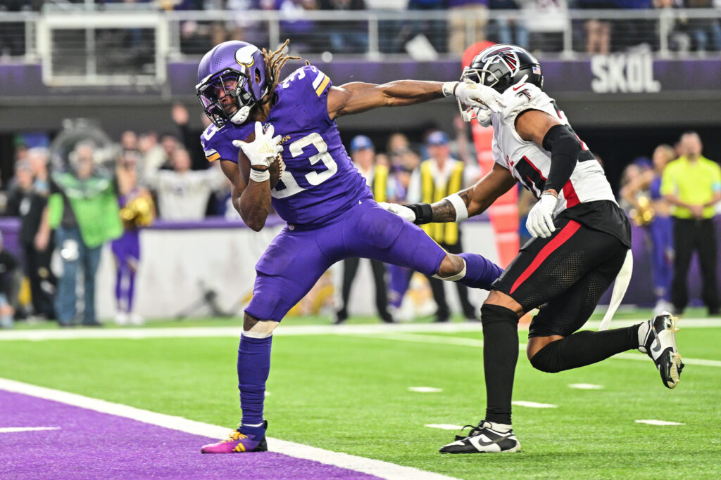 Minnesota Vikings running back Aaron Jones (33) runs for a touchdown as Atlanta Falcons cornerback A.J. Terrell (24) attempts to make the tackle  at U.S. Bank Stadium. 